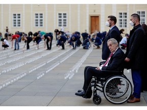 Czech President Milos Zeman watches as employees of Prague Castle light candles to commemorate the victims of the coronavirus disease (COVID-19) pandemic at Prague Castle in Prague, Czech Republic, May 10, 2021.