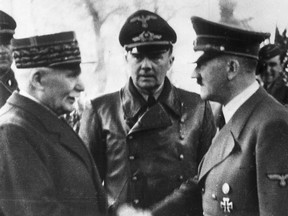 This Oct. 24, 1940 file photo shows German Chancellor Adolf Hitler, right, shaking hands with Head of State of Vichy France Marshall Philippe Petain, in occupied France.