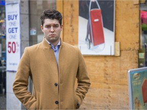 Harry Cockell, a Conservative candidate in the 2021 federal election, stands in front of the vandalized store on Robson Street. He says public safety and crime will be "a major ballot box issue" in next year's Vancouver election.