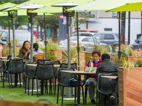 Customers eat at a restaurant patio in Vancouver.