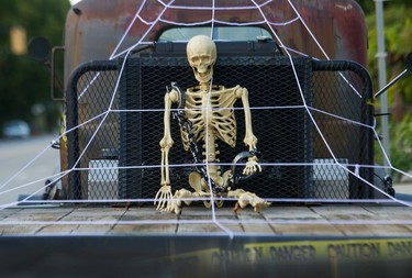 A skeleton is chained to the flat-bed of an old truck parked on West 4th in Vancouver on Oct. 11, 2021.