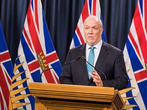 B.C. Premier John Horgan, seen here addressing the media on Oct. 21, said B.C. is already feeling the effects of climate change with wildfires, 'from devastating wildfires to intense heat waves and droughts.'