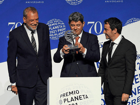 Winners of Spain's 2021 Premio Planeta award Jorge Diaz, Antonio Mercero and Augustin Martinez receive the trophy for their novel La Bestia, written under the pseudonym Carmen Mola, October 15, 2021.