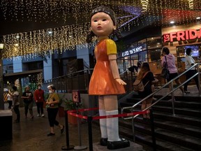 A 3-metre (10 ft) tall doll from Netflix series "Squid Game" is displayed outside a mall in Quezon City, Philippines, September 30, 2021.