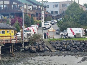 Ambulances waiting on shore to care for passengers rescued from Tofino Air float plane which was involved in a collision with a water taxi Monday in Tofino Harbour.