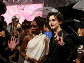 Cast member Timothee Chalamet gestures as he arrives for a UK screening of the film "Dune" in London, Britain October 18, 2021.