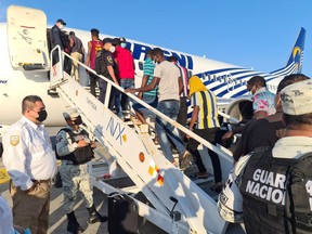 Haitian migrants board a plane for a voluntary repatriation flight from Tapachula, Chiapas, Mexico to the Haitian capital of Port-au-Prince, in this October 6, 2021 photo.