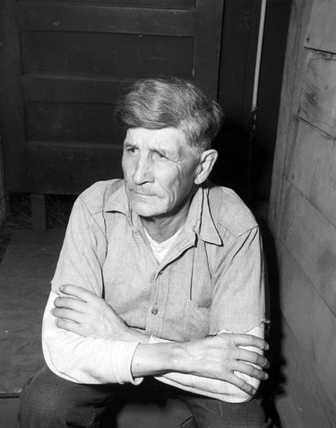 1948 Fraser River Flood - Abbotsford - Portrait of a man sitting on a stoop. 1948. Vancouver Sun.