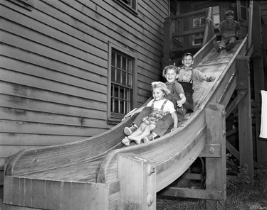 1948 Fraser River Flood - Abbotsford - Children play on a slide affixed to a building. 1948. Vancouver Sun.