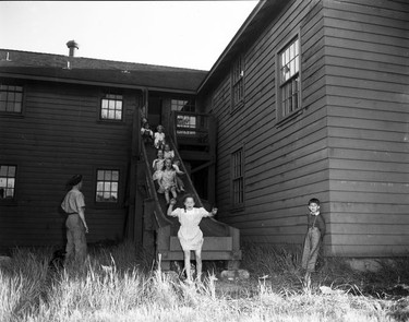 1948 Fraser River Flood - Abbotsford - Children play on a slide affixed to a building. 1948. Vancouver Sun.