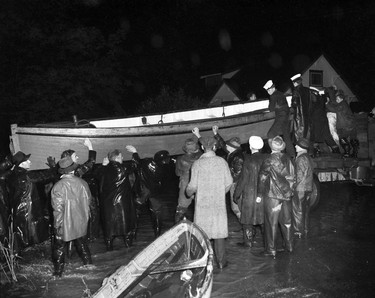 1948 Fraser River Flood - Nicomen Island residents marooned by flood are evacuated by RCN crews in whaleboat from HMCS Discovery. Photo ran in Sun on May 29,1948. Vancouver Sun. (48/1186) [PNG Merlin Archive]