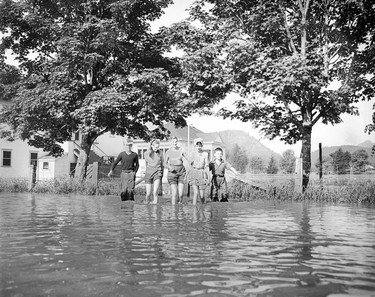 1948 Fraser River Flood - Rosedale - A group of adolescents plod through ankle-deep flood waters. 1948. Vancouver Sun.