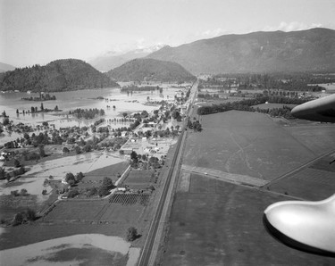 1948 Fraser River Flood - Rosedale - An aerial view of train tracks intersecting flooded land. 1948. Vancouver Sun.