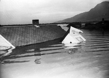 1948 Fraser River Flood - Ruskin - Part of a house can be seen floating in flood water. 1948. Vancouver Sun.