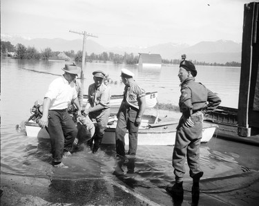 1948 Fraser River Flood - Sumas - Yarrows - Service and civilian men unload a sheep from a small motorboat. 1948. Vancouver Sun.