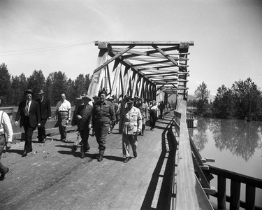 1948 Fraser River Flood - Sumas - Yarrows - A group of mostly offical-looking men in suits and what appear to be high-ranking serivcemen cross a bridge. 1948. Vancouver Sun.