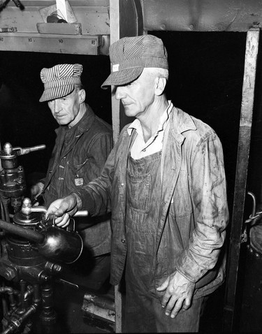 1948 Fraser River Flood - Vedder Canal - Two elderly men (possibly mechanics) work on something outside of the frame. 1948. Vancouver Sun.