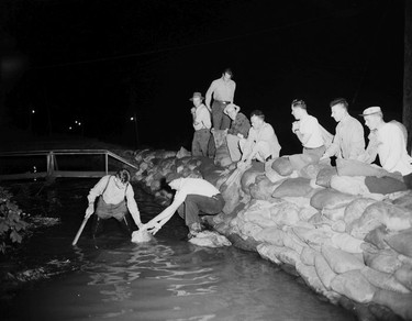 1948 Fraser River Flood - Vedder Canal - Men work outside at night to stack sandbags. 1948. Vancouver Sun. (48/1179) [PNG Merlin Archive]