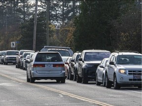 People line up for gas on West Saanich Road near the Peninsula Co-op station at Birch Road on Wednesday.