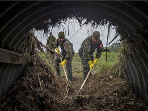 Edmonton troops clear a clogged culvert in the flood relief effort in the lower mainland of British Columbia as heavy rains washed away roads, railway track and flooded farms across the province last week.