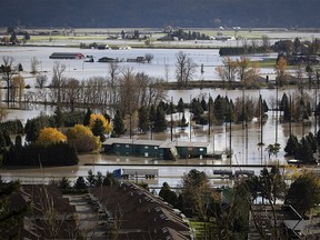 Abandoned transport trucks are seen on the Trans-Canada Highway in a flooded area of Abbotsford, British Columbia, on Tuesday, Nov. 16, 2021.