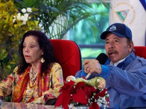 Handout picture released by Nicaragua's presidency press office of Nicaragua's President and presidential candidate Daniel Ortega speaking next to his wife and Vice-President Rosario Murillo during a broadcast television message regarding the general election, in Managua, Nicaragua on Nov. 7, 2021.