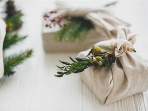 For gift wrap, reuse products from around the house, like cloth bags and newspapers. GETTY IMAGES