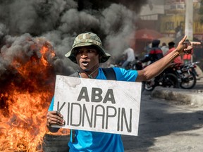 A Haitian protests an upsurge in kidnappings perpetrated by gangs, in Port-au-Prince, on December 10, 2020.