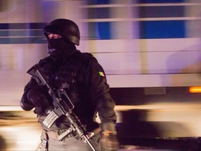 In this file photo, Mexican police stand guard on street during scurity operation in Bahia de Banderas, Nayarit State, on Aug. 16, 2016.