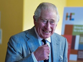 Britain's Prince Charles smiles during his visit to Homerton College at the University of Cambridge, in Cambridge, England, Nov. 23, 2021.