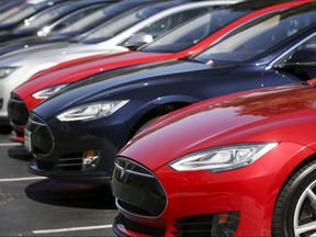 A row of Tesla Model S sedans are seen outside the company's headquarters in Palo Alto, Calif., April 30, 2015.