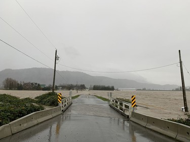 Photo of Bouwman Road in Abbotsford, where a drainage ditch has overtopped the road.