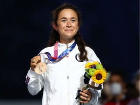 Bronze medallist Molly Seidel of the United States celebrates on the podium.