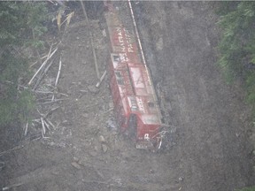 A Canadian Pacific locomotive and its cars that were knocked off of the train track by heavy rains and mudslides earlier in the week is pictured in the Fraser Canyon near Hope, B.C., Thursday, November 18, 2021.