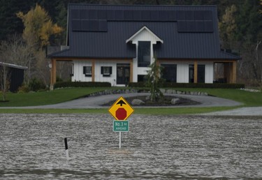 Rising waters are seen surrounding a home in Chilliwack, B.C., Tuesday, November 16, 2021.