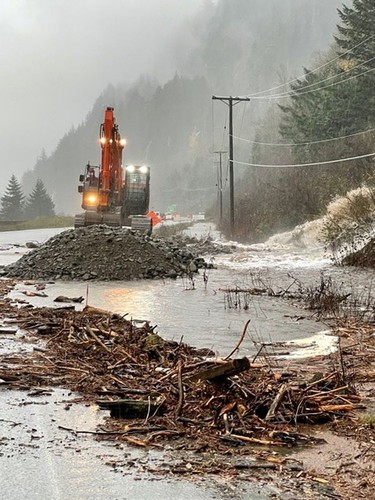 An excavator clears debris on a road after landslide and flooding British Columbia, Canada, November 15, 2021. B.C. Ministry of Transportation and Infrastructure.
