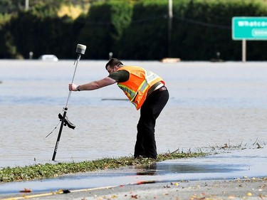 An engineer plots the GPS coordinates of flood water after rainstorms caused flooding and landslides in Abbotsford, British Columbia, Canada November 16, 2021.