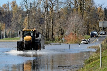 A tractor makes its way through flood water after rainstorms caused flooding and landslides in Abbotsford, British Columbia, Canada November 16, 2021.