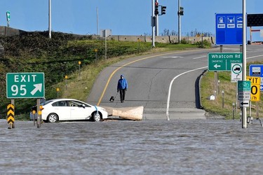 A man walks his dog down the Trans Canada ramp days after rainstorms lashed the western Canadian province of British Columbia, triggering landslides and floods, shutting highways, in Abbotsford.