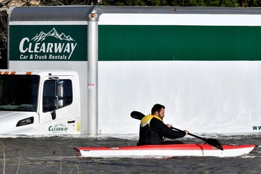 A paddler kayaks past a submerged truck days after rainstorms lashed the western Canadian province of British Columbia, triggering landslides and floods, and shutting highways, in Abbotsford, British Columbia, Canada November 17, 2021.