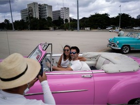 Tourists from Spain have their pictures taken at the Revolution square in Havana, Cuba, November 23, 2021.