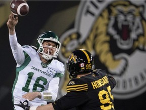 Saskatchewan Roughriders quarterback Isaac Harker throws under pressure from Tiger-Cats defensive end Julian Howsare during CFL action in Hamilton on Nov. 20.