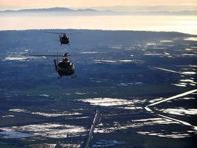 Royal Canadian Air Force helicopters survey the scene after rainstorms lashed the western Canadian province of British Columbia, triggering landslides and floods, shutting highways, in Abbottsford, B.C., Sunday, Nov. 21, 2021.