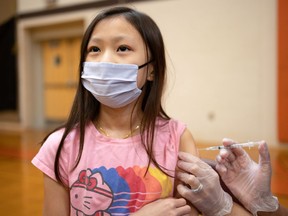 Olivia Lav, 9, receives the Pfizer-BioNTech coronavirus disease (COVID-19) vaccine in Collegeville, Pennsylvania, U.S., November 6, 2021. REUTERS/Hannah Beier
