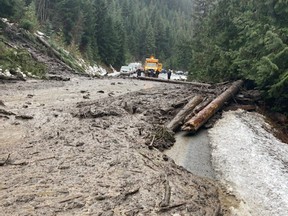 A car is submerged in flood waters on a farm after rainstorms caused flooding and landslides in Abbotsford.