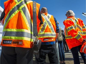 WorkSafe BC vests were worn as hundreds of people attend Day of Mourning at Jack Poole Plaza in Vancouver, on April 28, 2019.