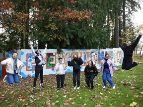 Students stand in front of the "Every Child Matters" mural in Surrey.