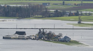 A home and farm is surrounded by flood waters in Abbotsford, BC, November, 17, 2021.