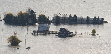 Flood waters surround a home and farm in Abbotsford, BC, November, 17, 2021.