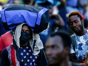 Migrants, mostly Haitians, walk as they take part in a caravan heading to the U.S. border, near Tapachula, Mexico November 26, 2021.